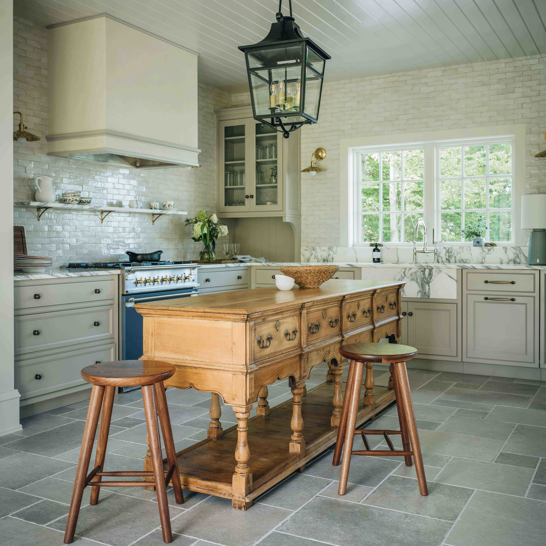 a kitchen with a table and stools in it