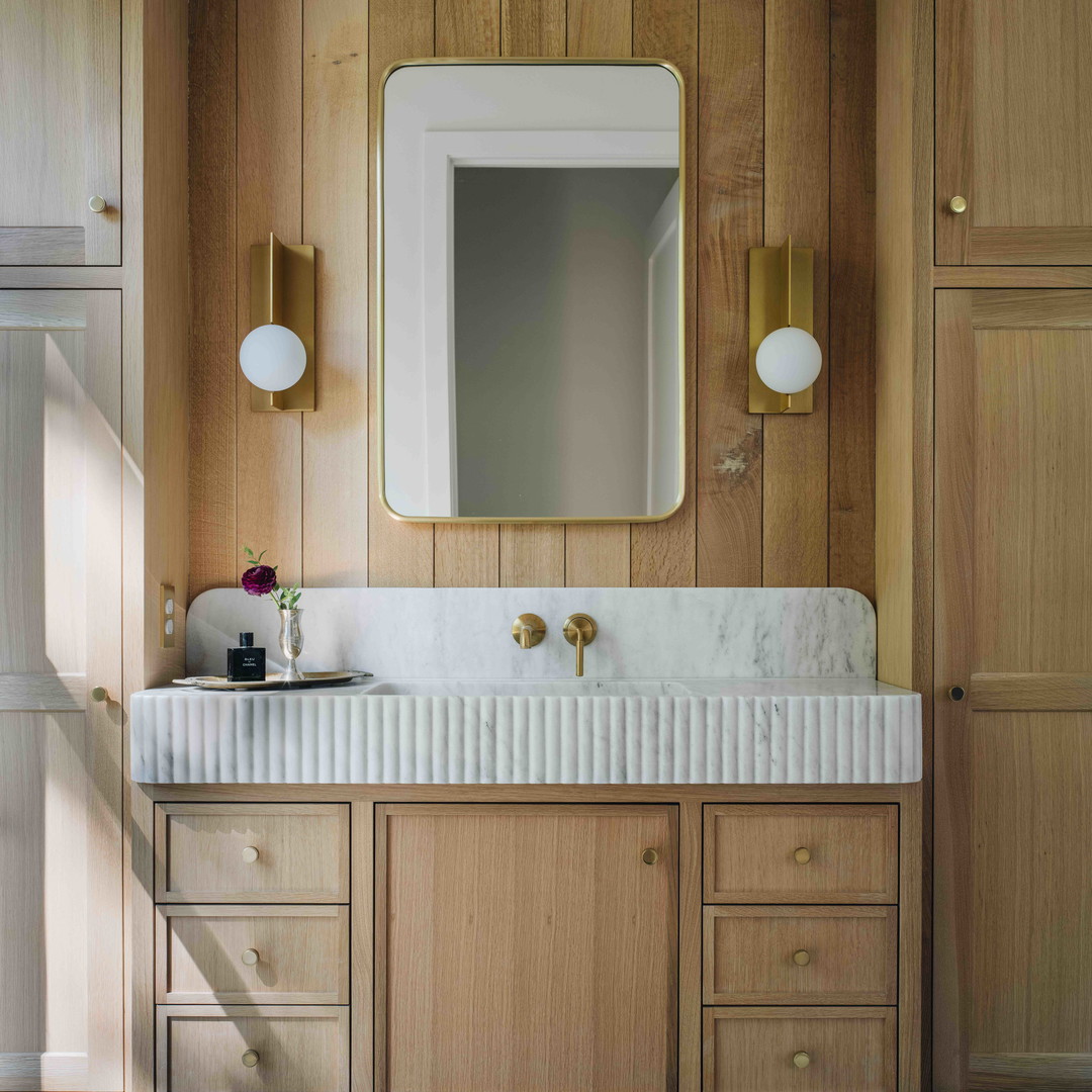 a bathroom with wooden cabinets and a marble counter top