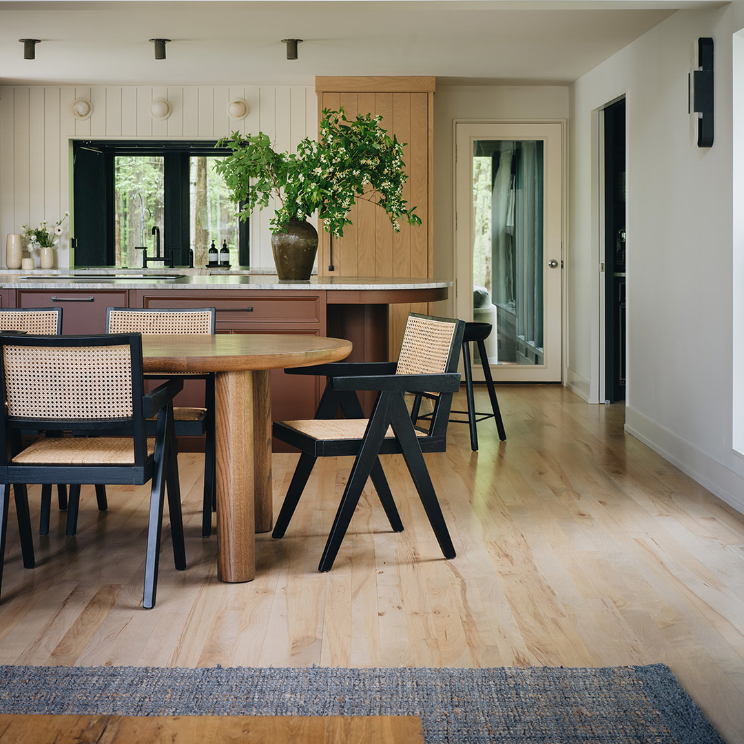 a kitchen with a table and chairs and a potted plant