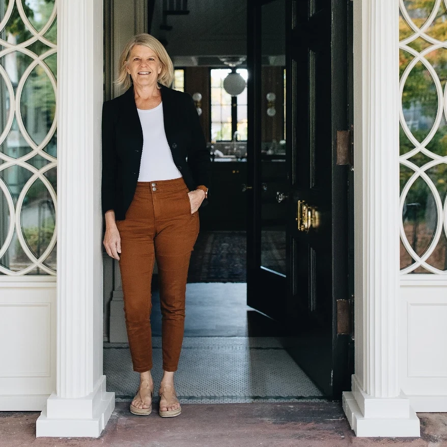 a woman standing in a doorway of a house