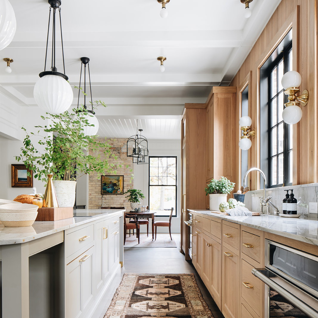 a large kitchen with a long counter and wooden cabinets