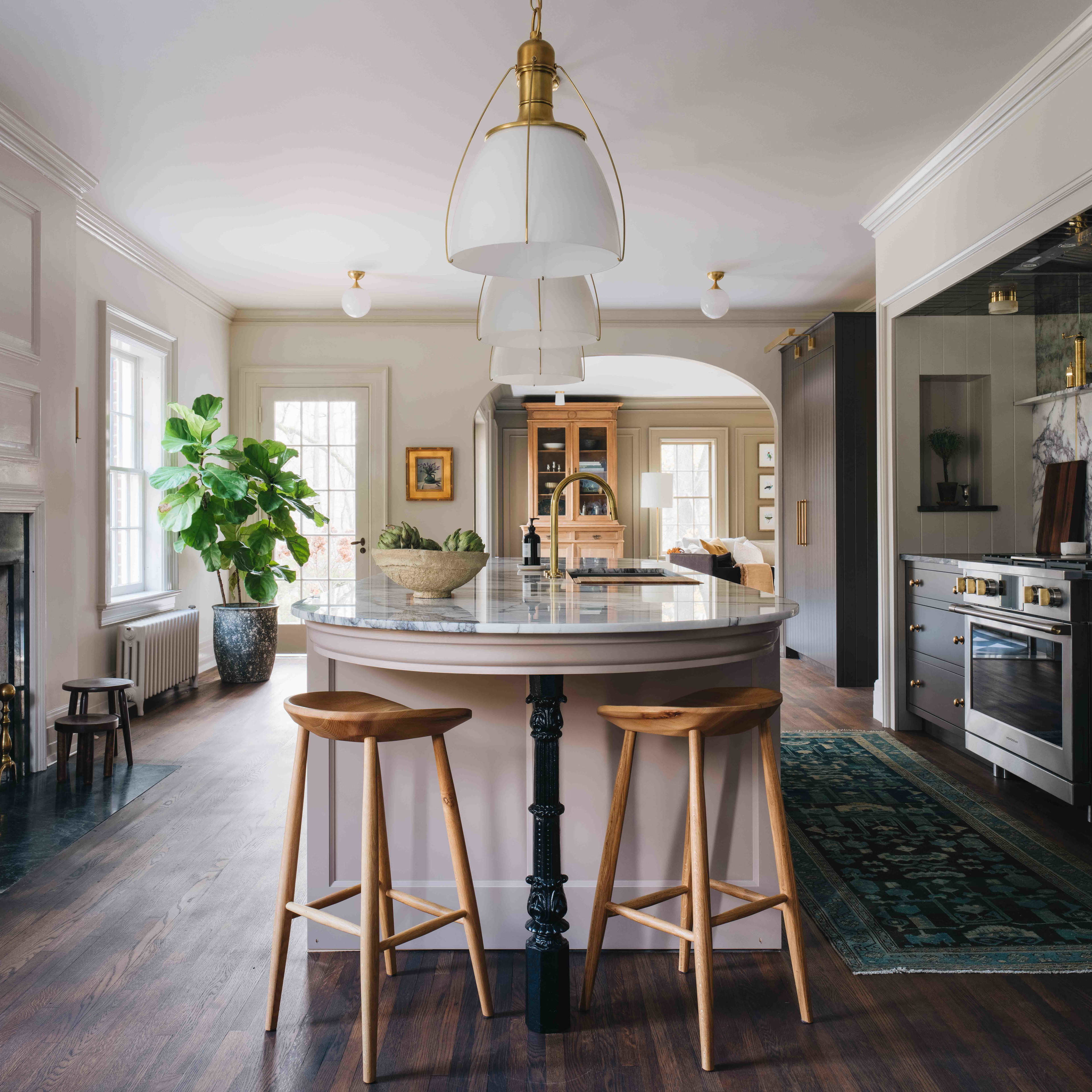 a kitchen with a center island and two stools