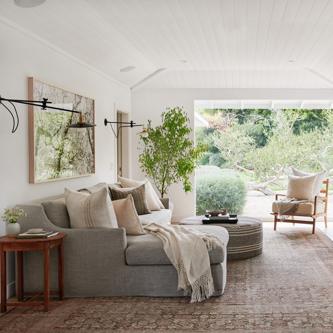 a living room filled with furniture and a large window