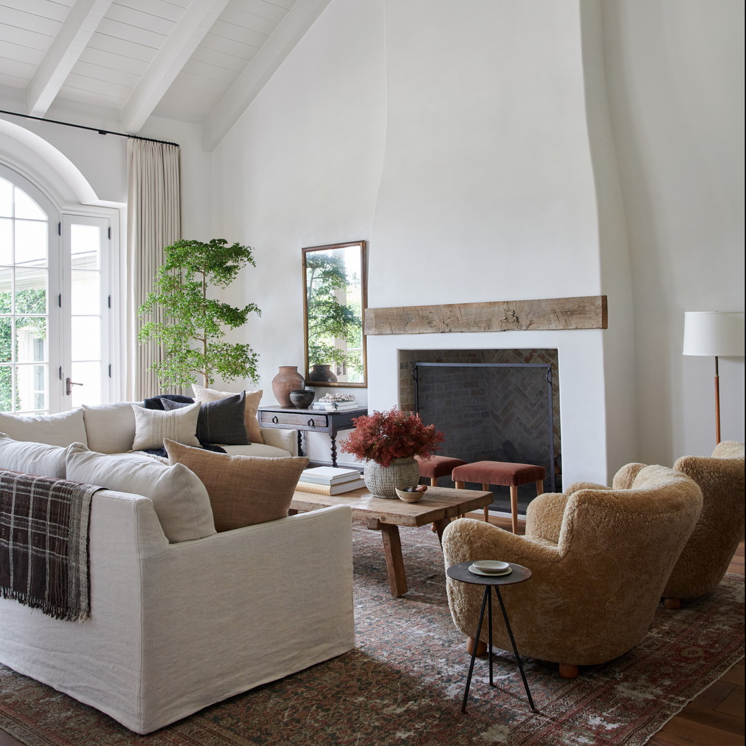 a living room filled with furniture and a fire place