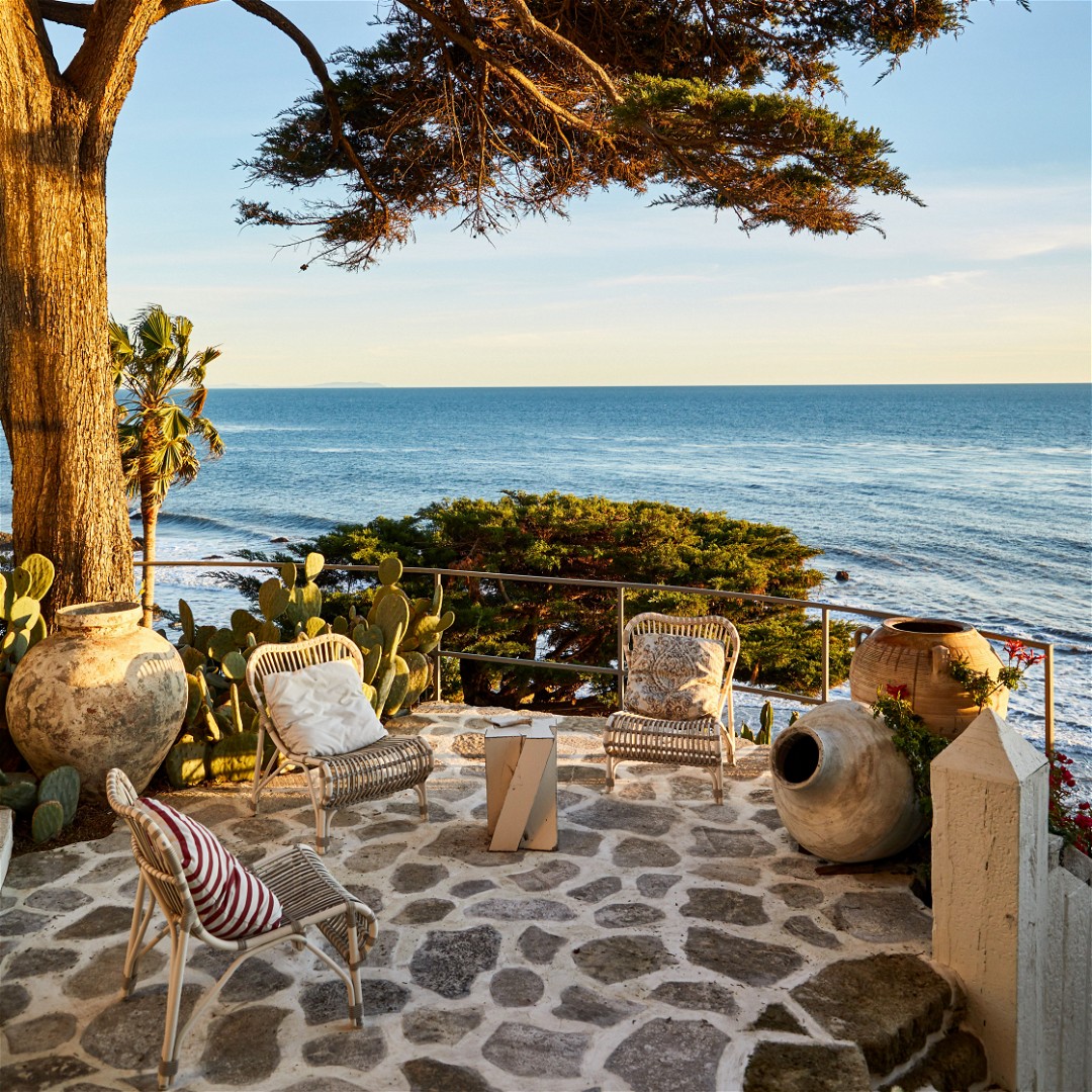 a patio with a view of the ocean