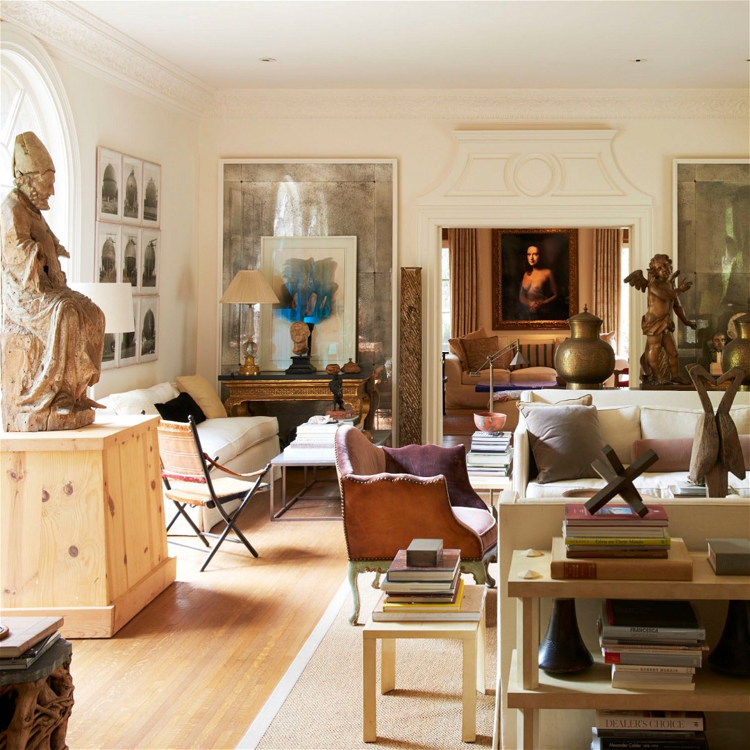 a living room filled with furniture and a statue