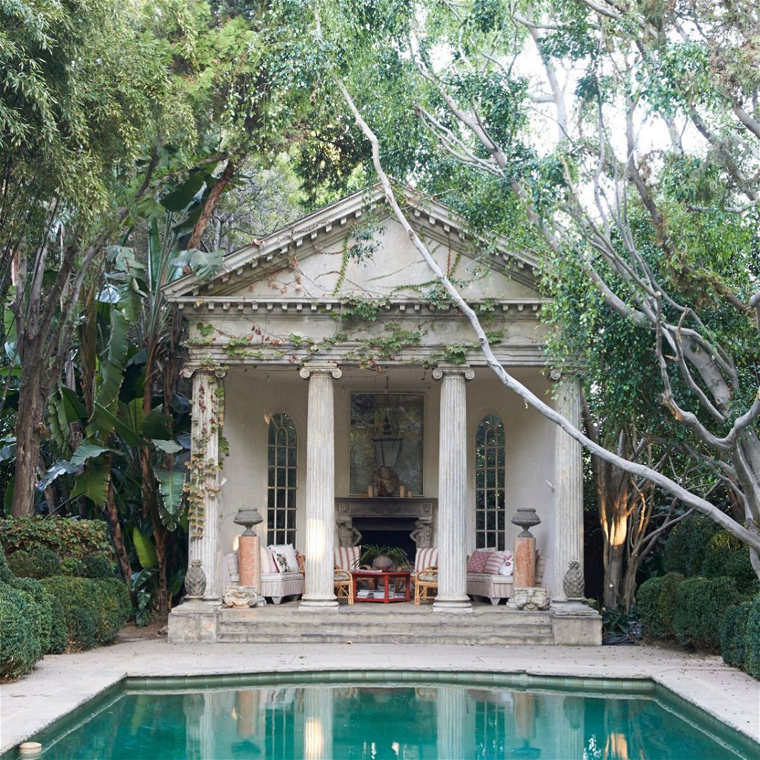 a pool with a gazebo in the middle of it