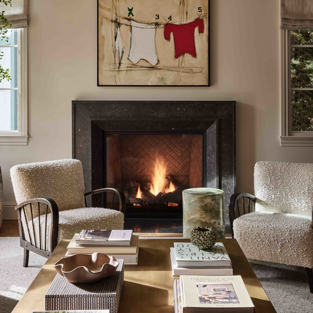 a living room filled with furniture and a fire place