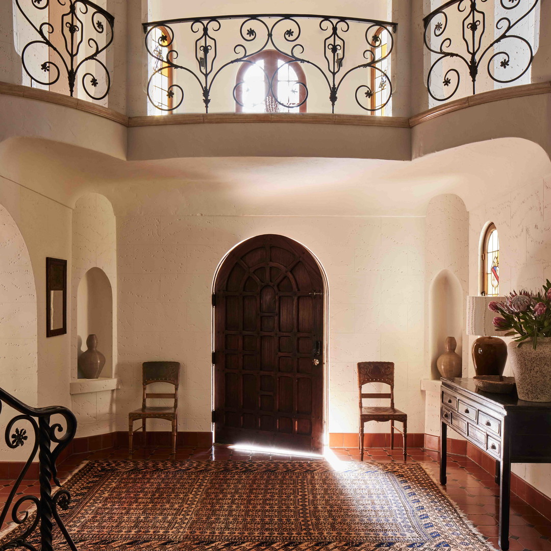 a room with a large rug and a doorway