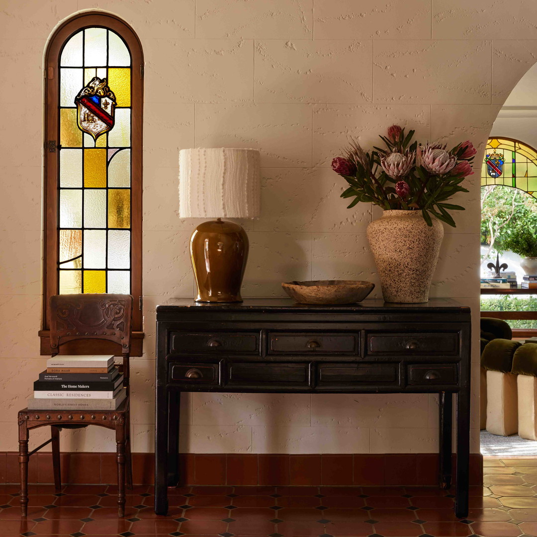 a table with a vase of flowers on top of it