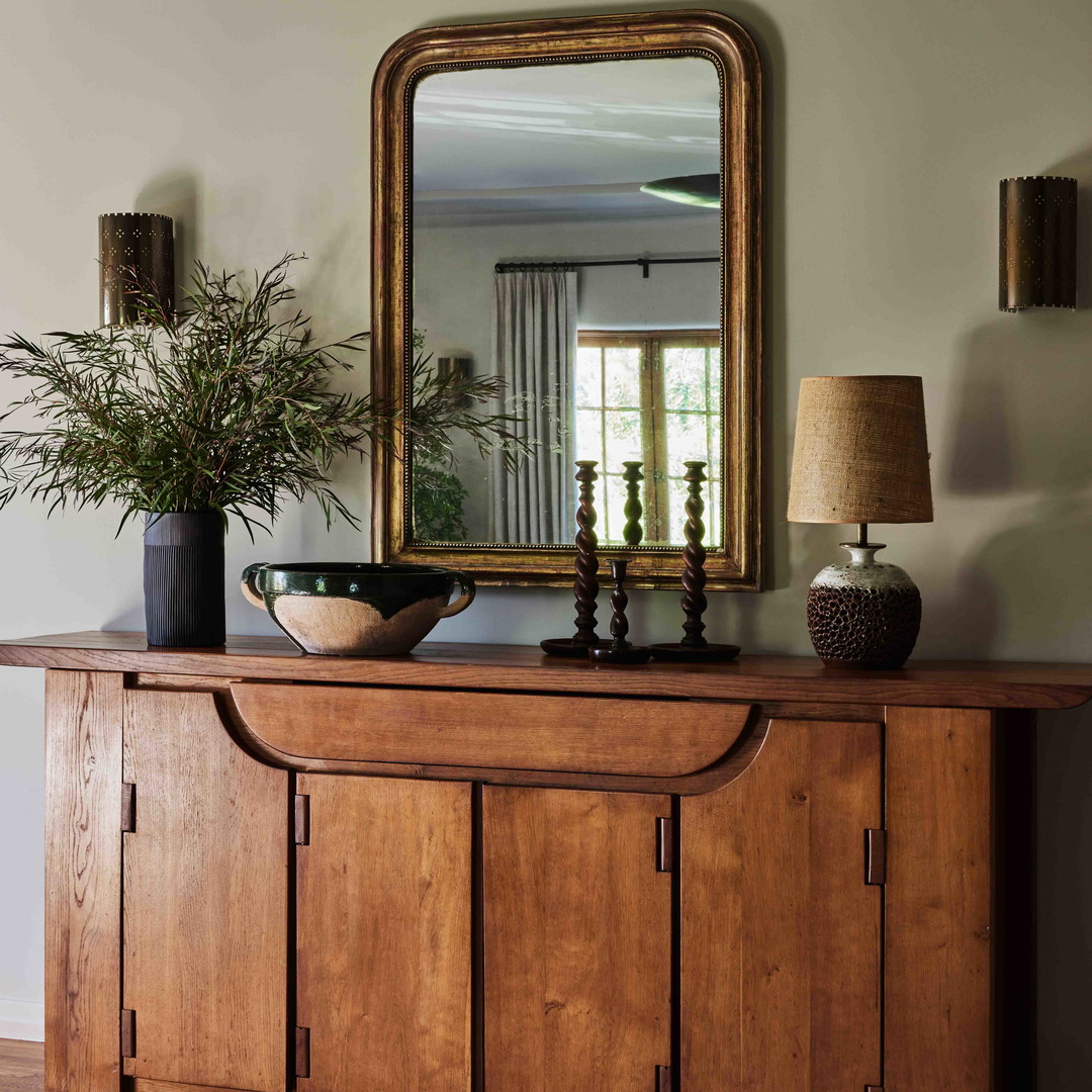 a wooden cabinet with a mirror on top of it