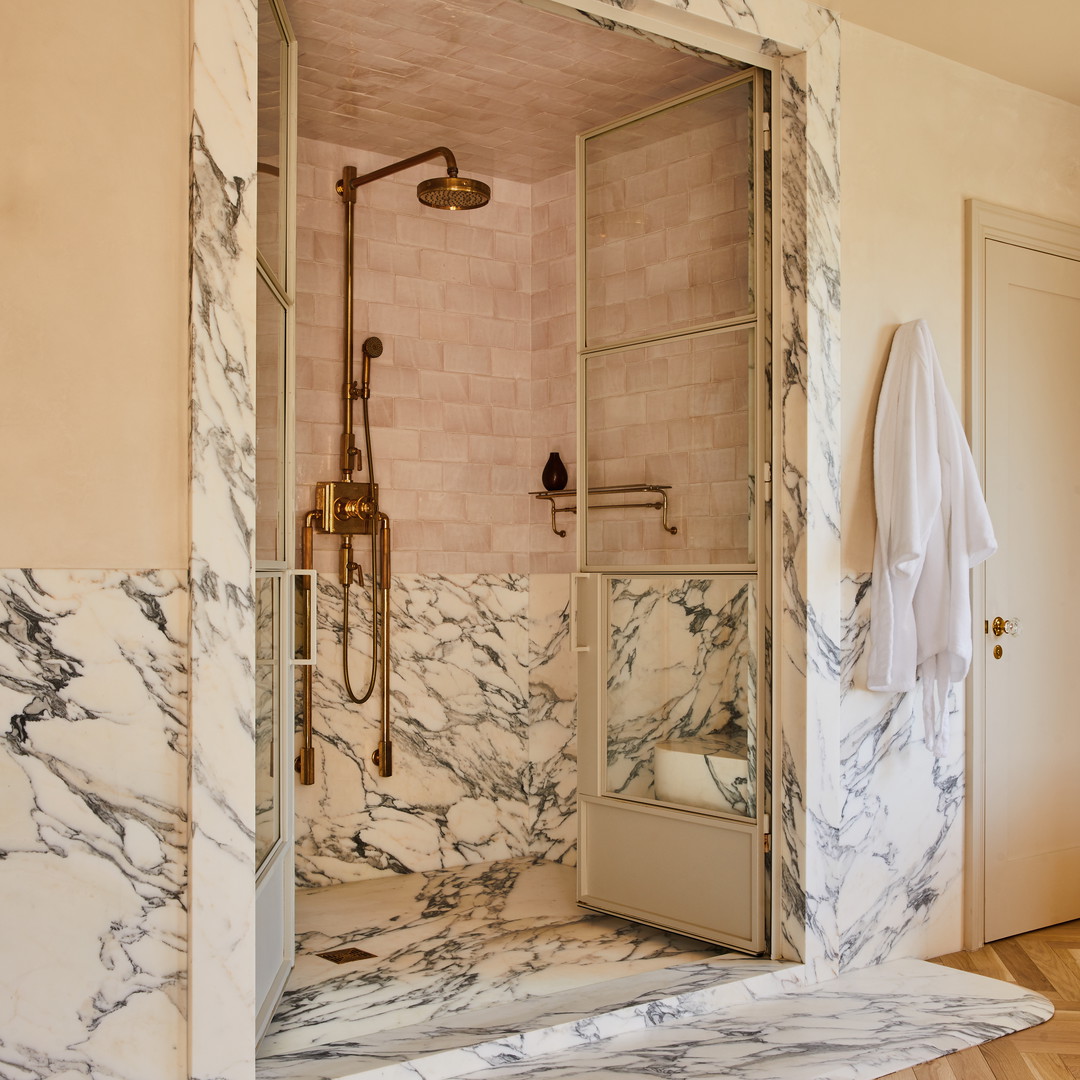 a walk in shower sitting inside of a bathroom