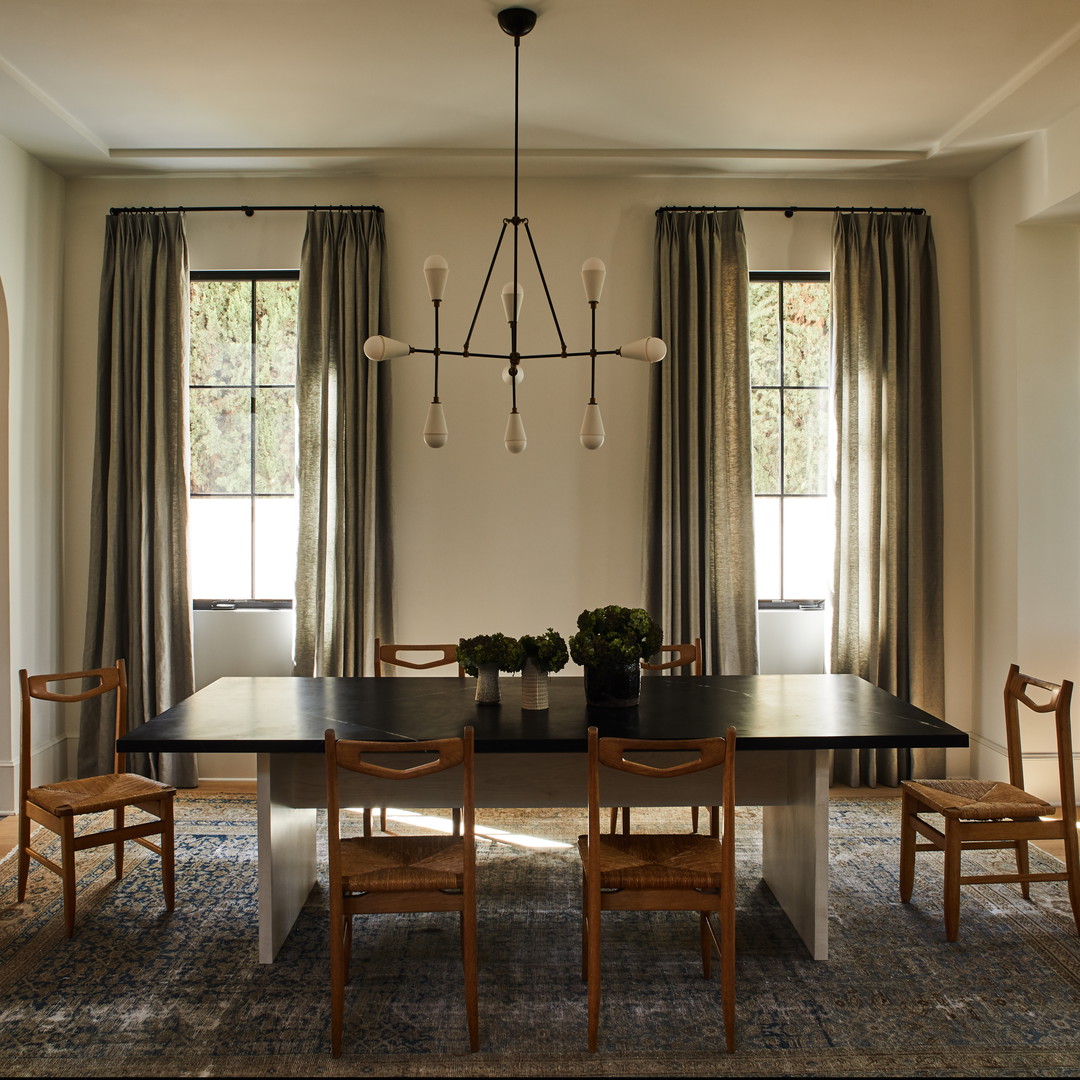 a dining room table with chairs and a chandelier