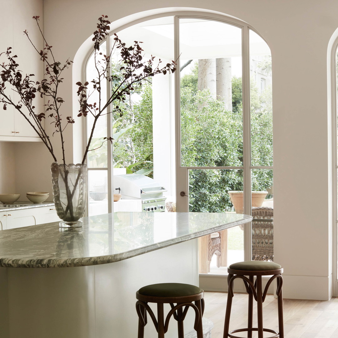 a kitchen with two stools and a counter