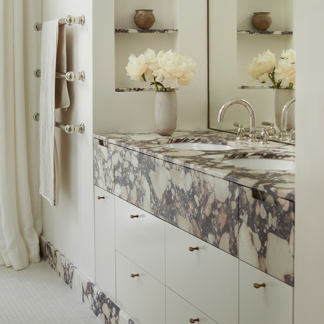 a bathroom with two sinks and a mirror