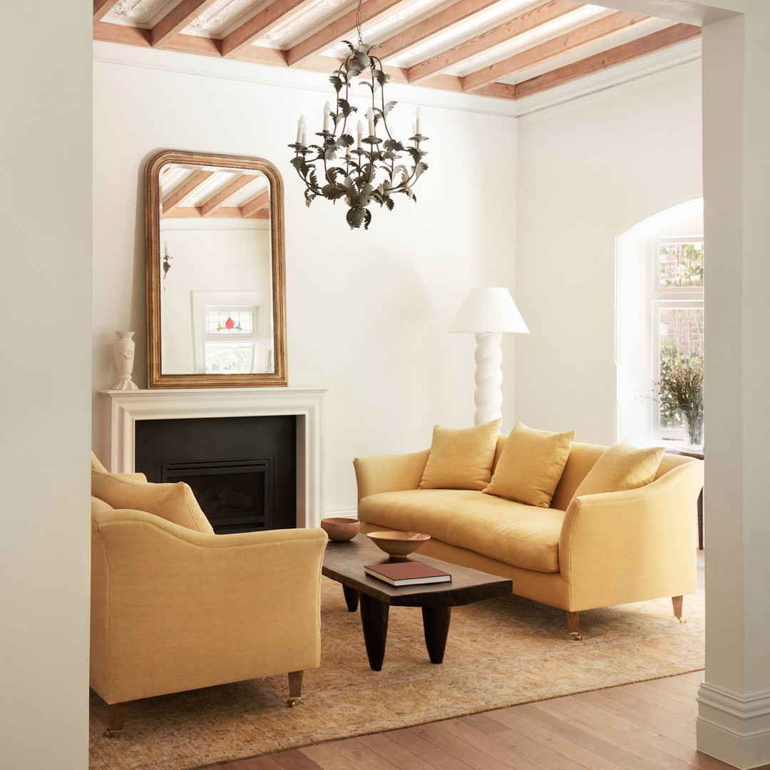 a living room filled with furniture and a chandelier