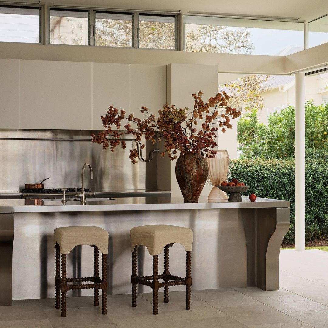 a kitchen with a center island with stools