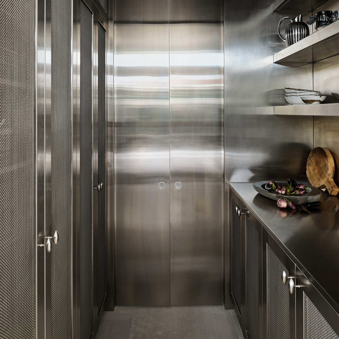 a kitchen with stainless steel cabinets and counters