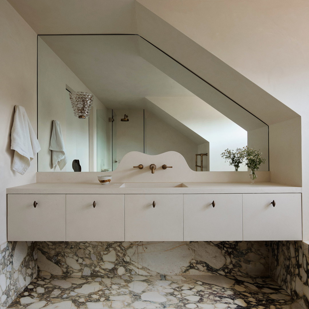 a bathroom with a marble floor and a large mirror