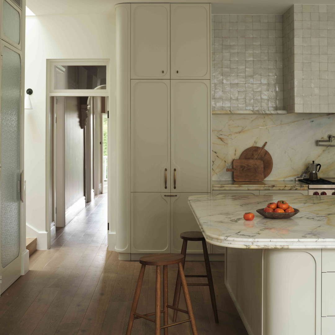 a kitchen with a marble counter top and white cabinets