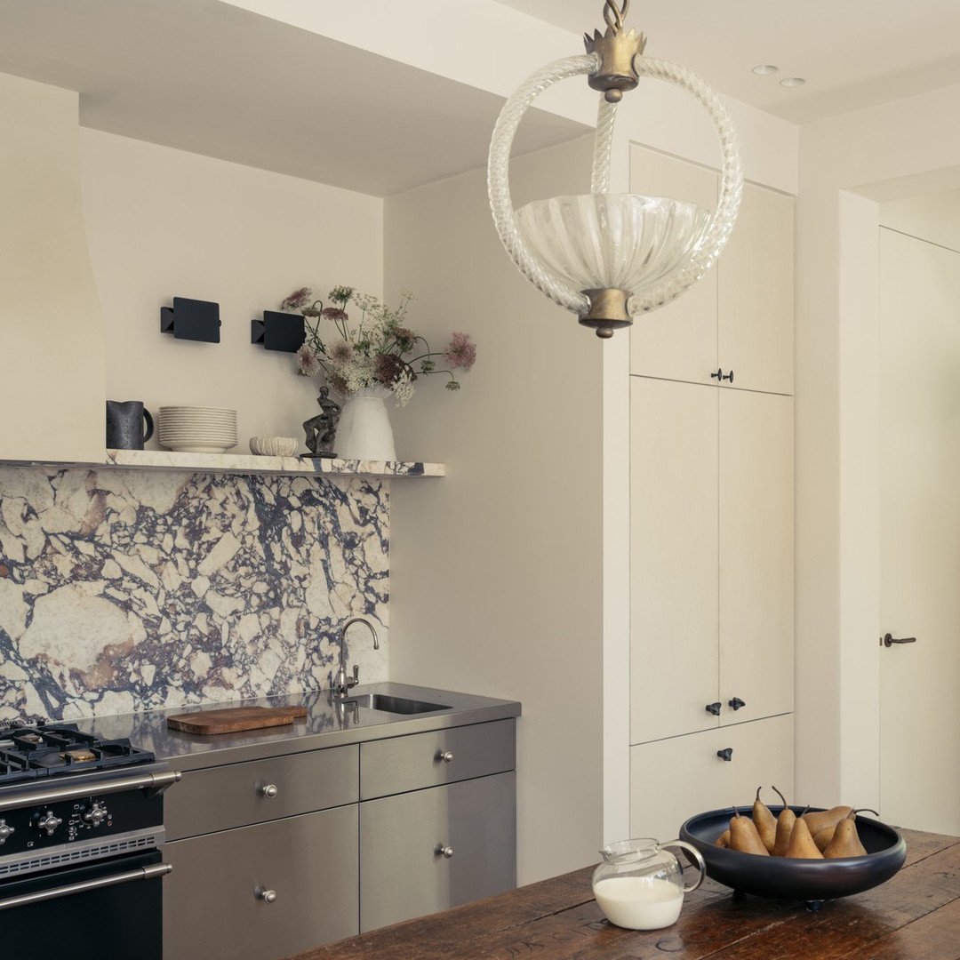 a kitchen with a wooden counter top and a bowl of fruit on the counter