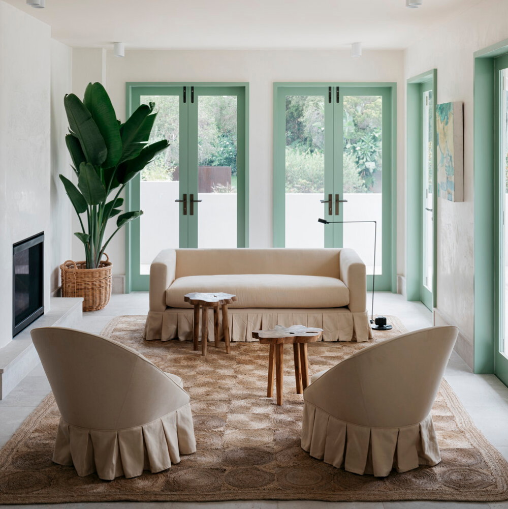 a living room filled with furniture and a potted plant