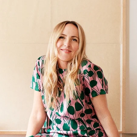 a woman sitting on a desk in a room