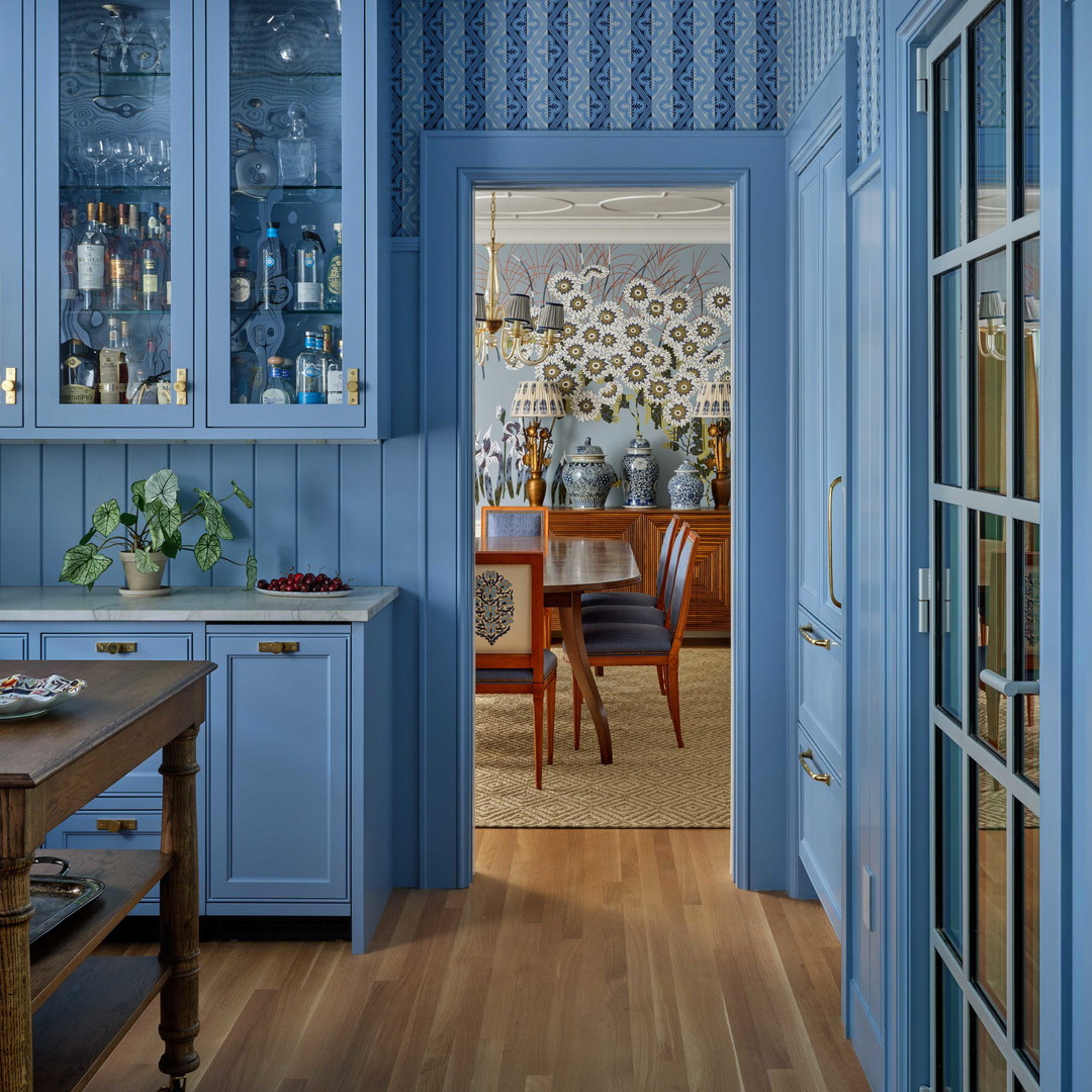 a kitchen with blue walls and wooden floors