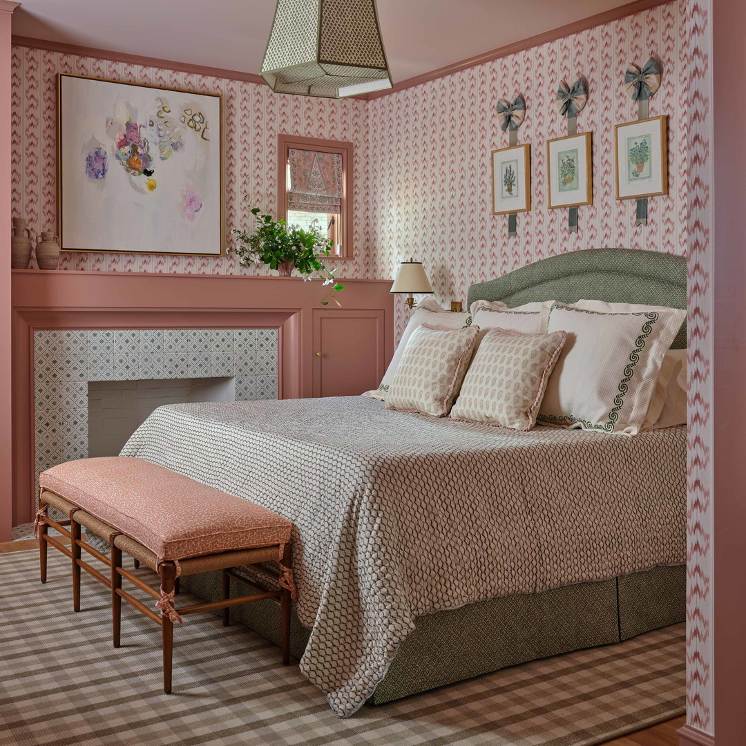 a bedroom with pink walls and a large bed