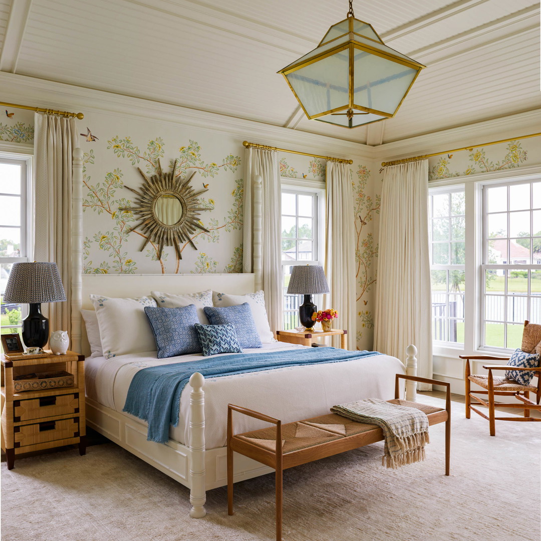 a bedroom with a large bed and a chandelier