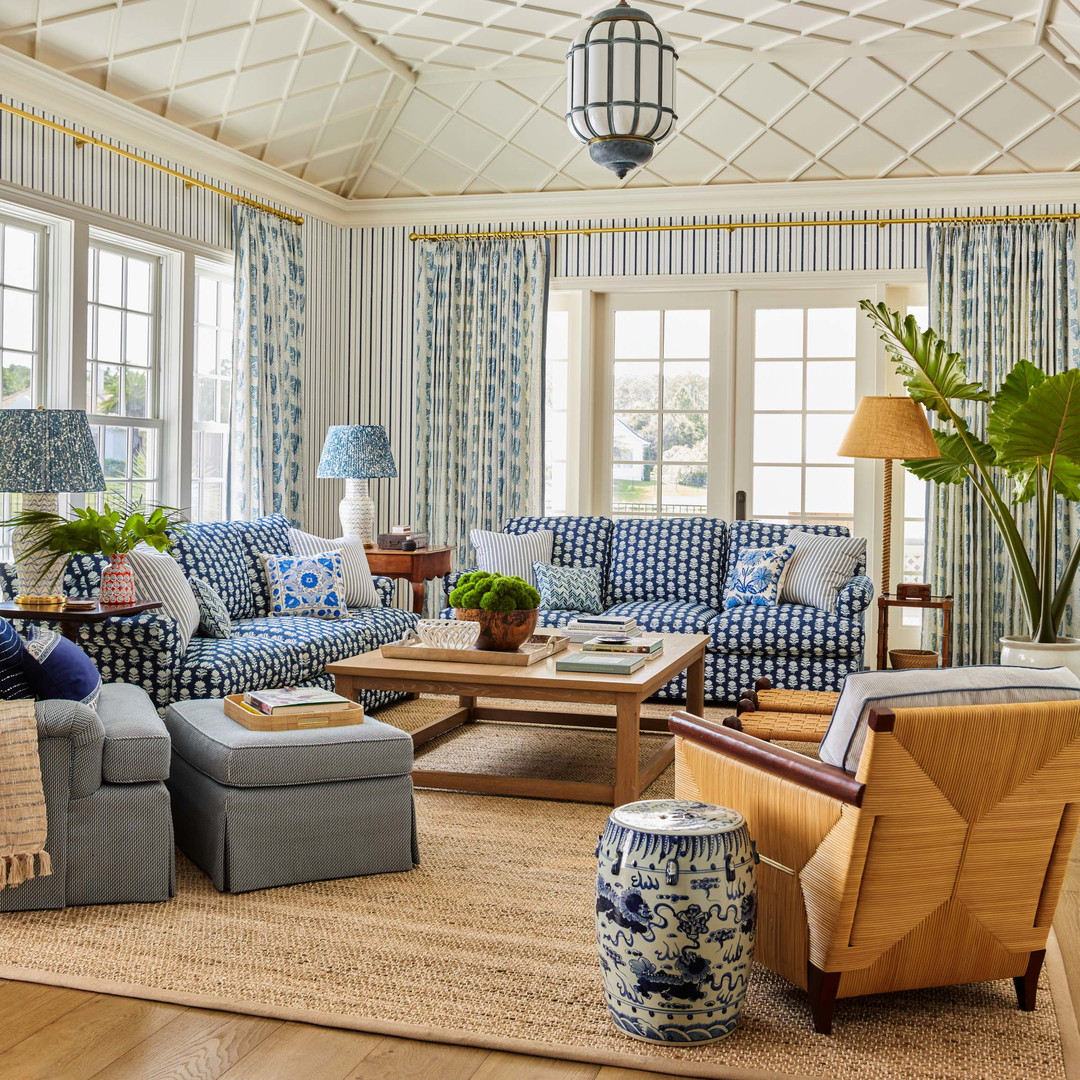 a living room filled with blue and white furniture