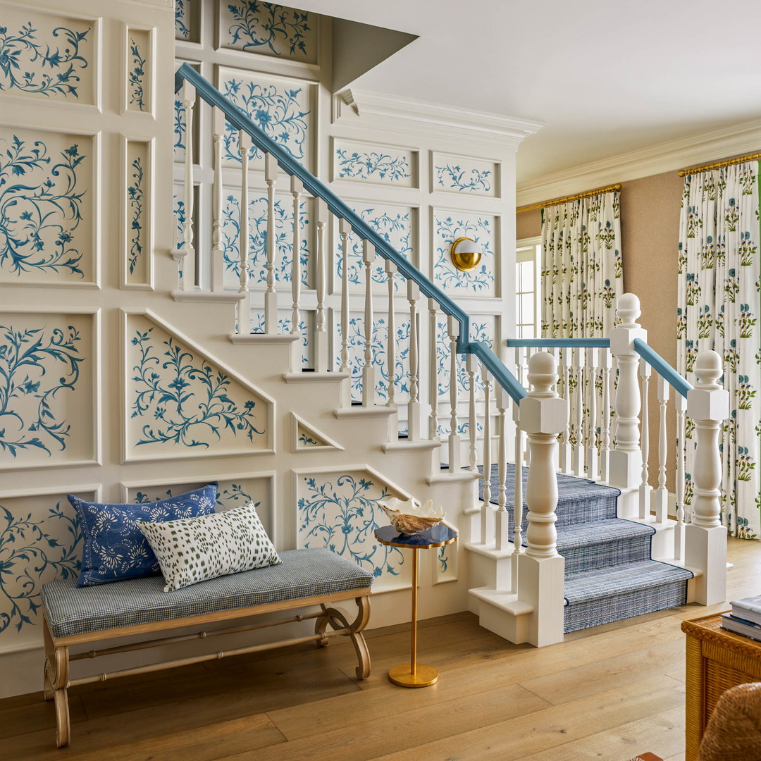 a living room with a couch and a stair case