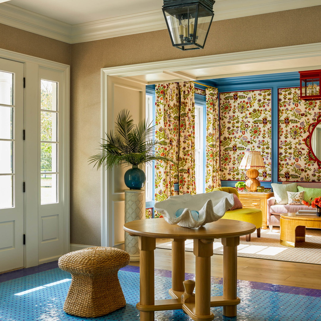 a living room with a table and chairs