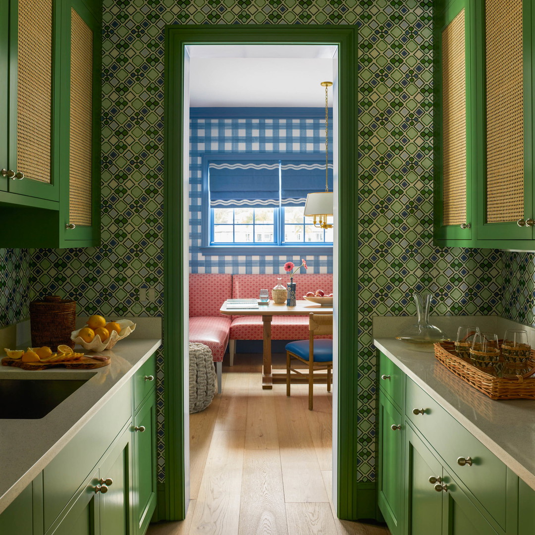 a kitchen with green cabinets and a wooden floor