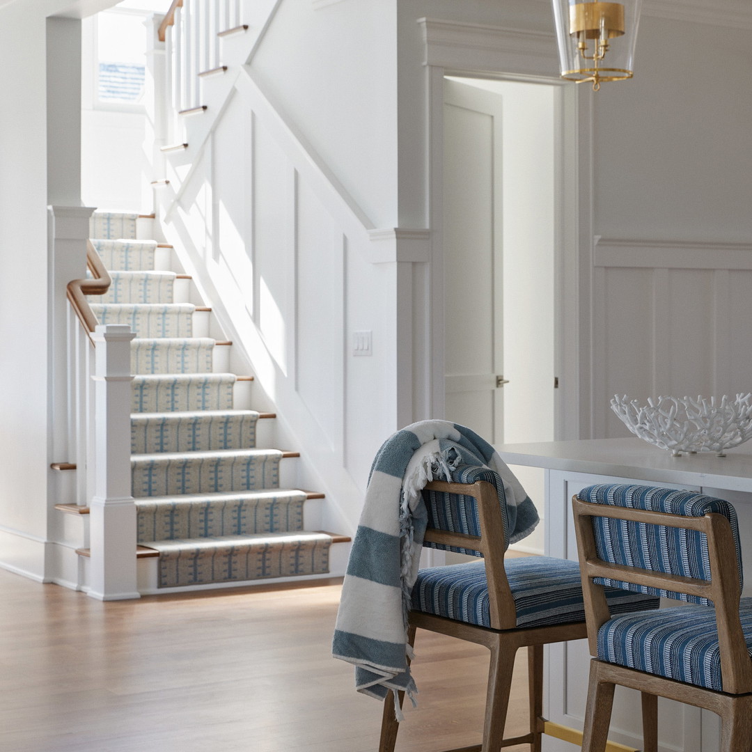 a living room with a stair case next to a set of stairs