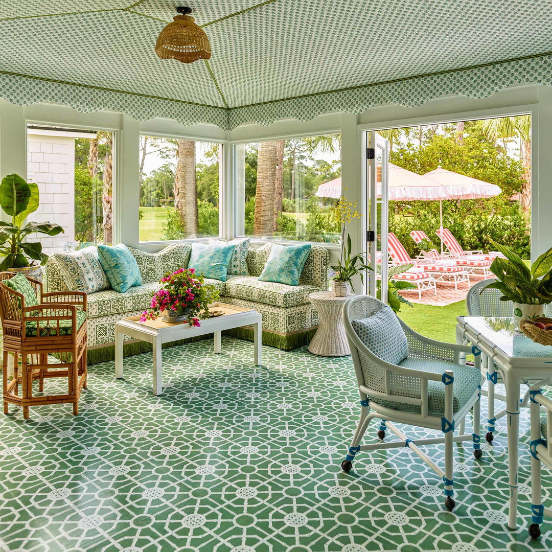 a living room with a couch, chairs, tables and umbrellas