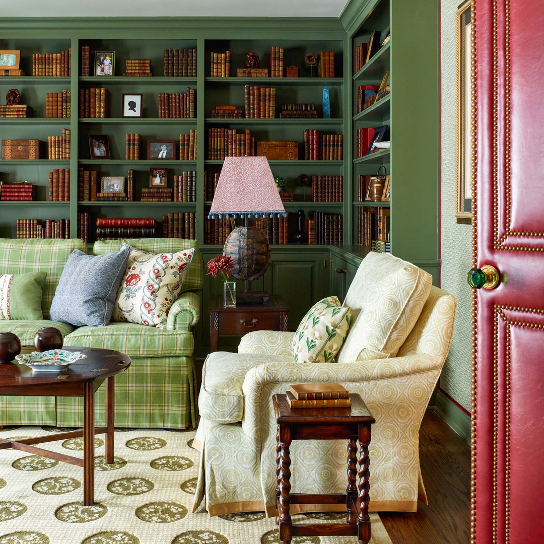 a living room filled with lots of furniture and bookshelves