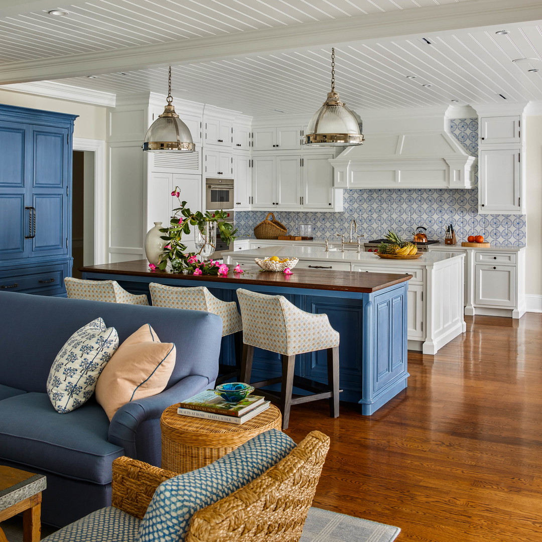 a living room filled with furniture and a kitchen