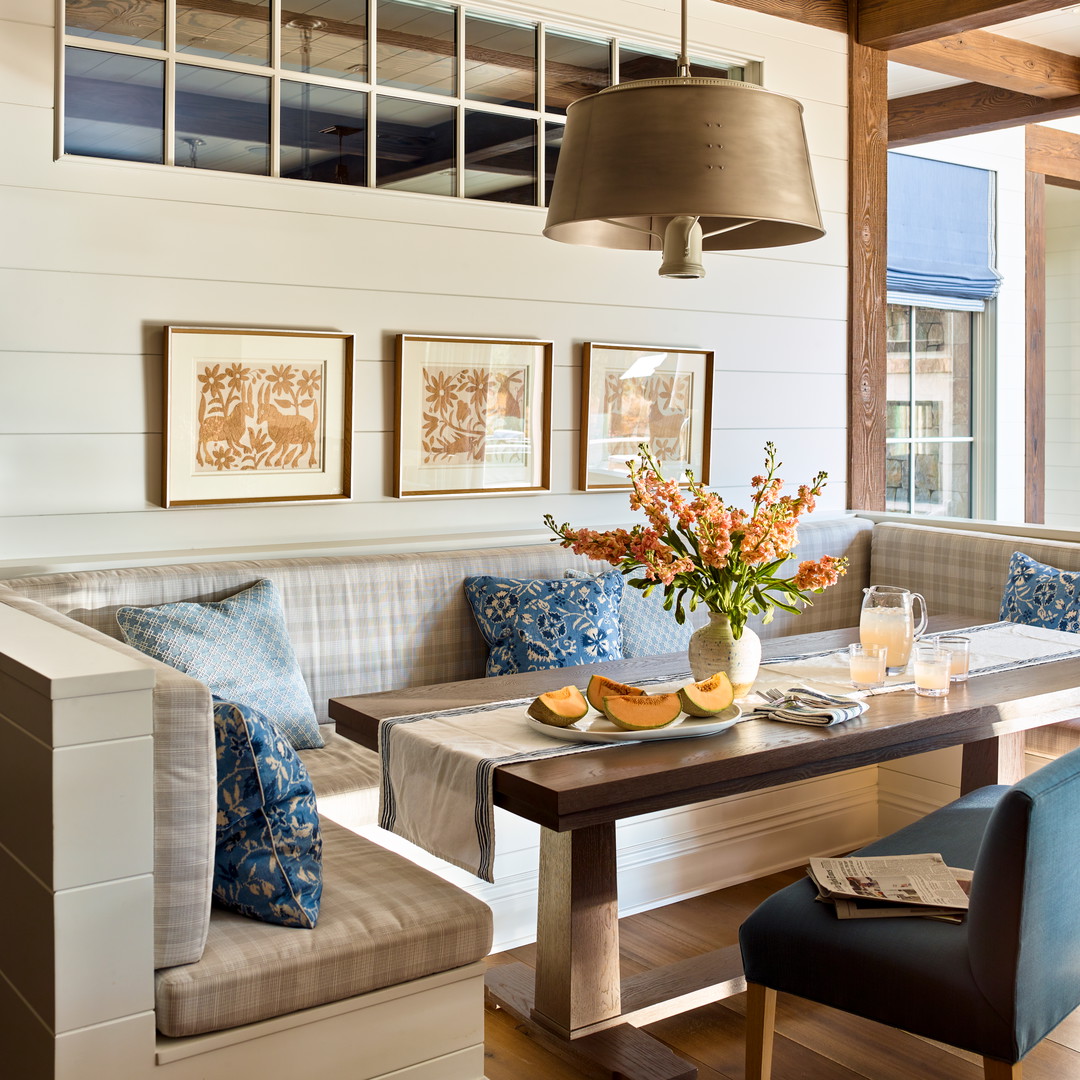 a dining room table with a vase of flowers on it