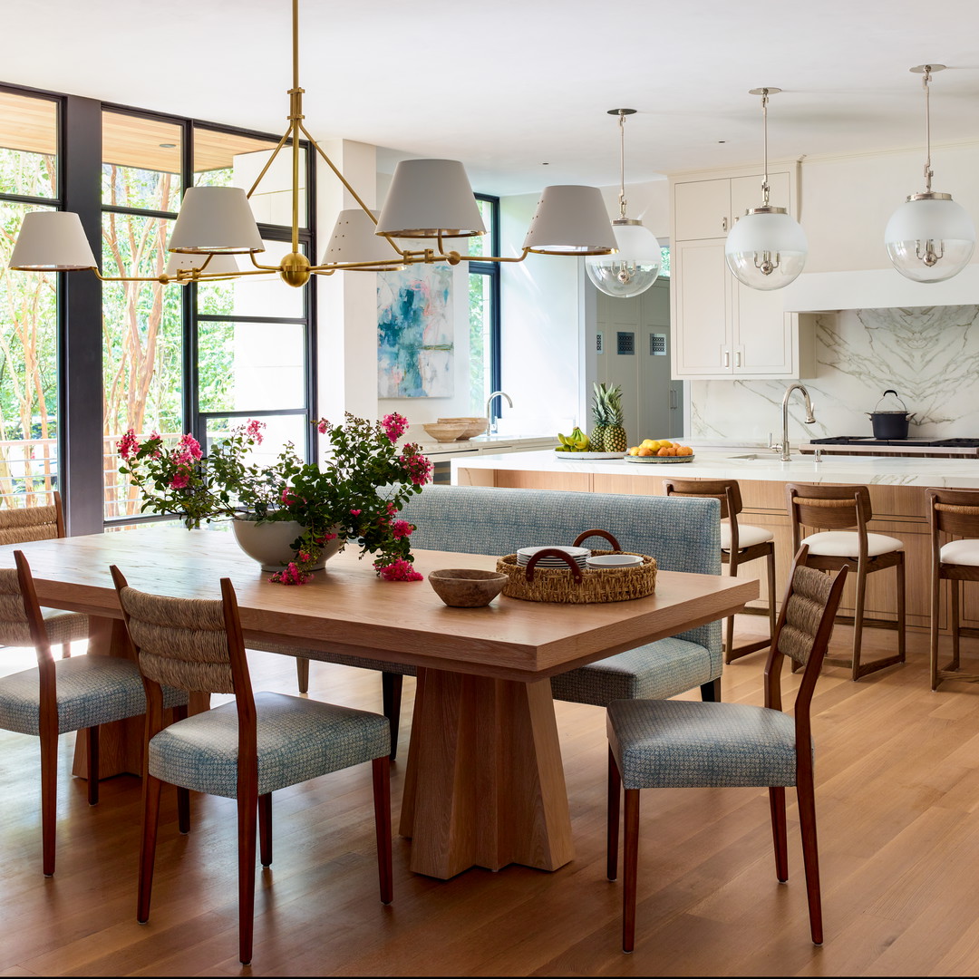 a dining room table with chairs and a basket of flowers