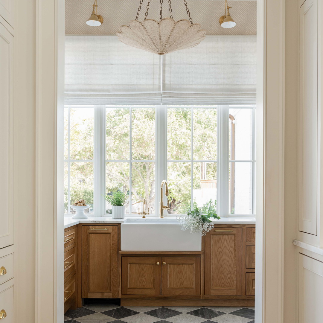 a bathroom with a checkered floor and a chandelier