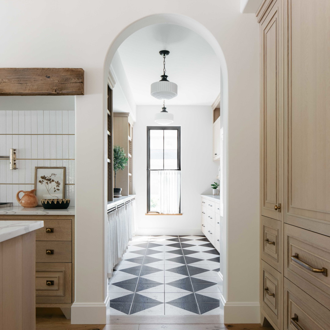 a kitchen with a black and white checkered floor