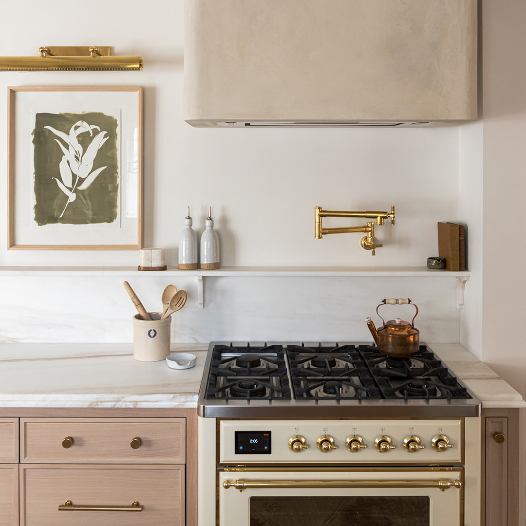 a stove top oven sitting under a light fixture