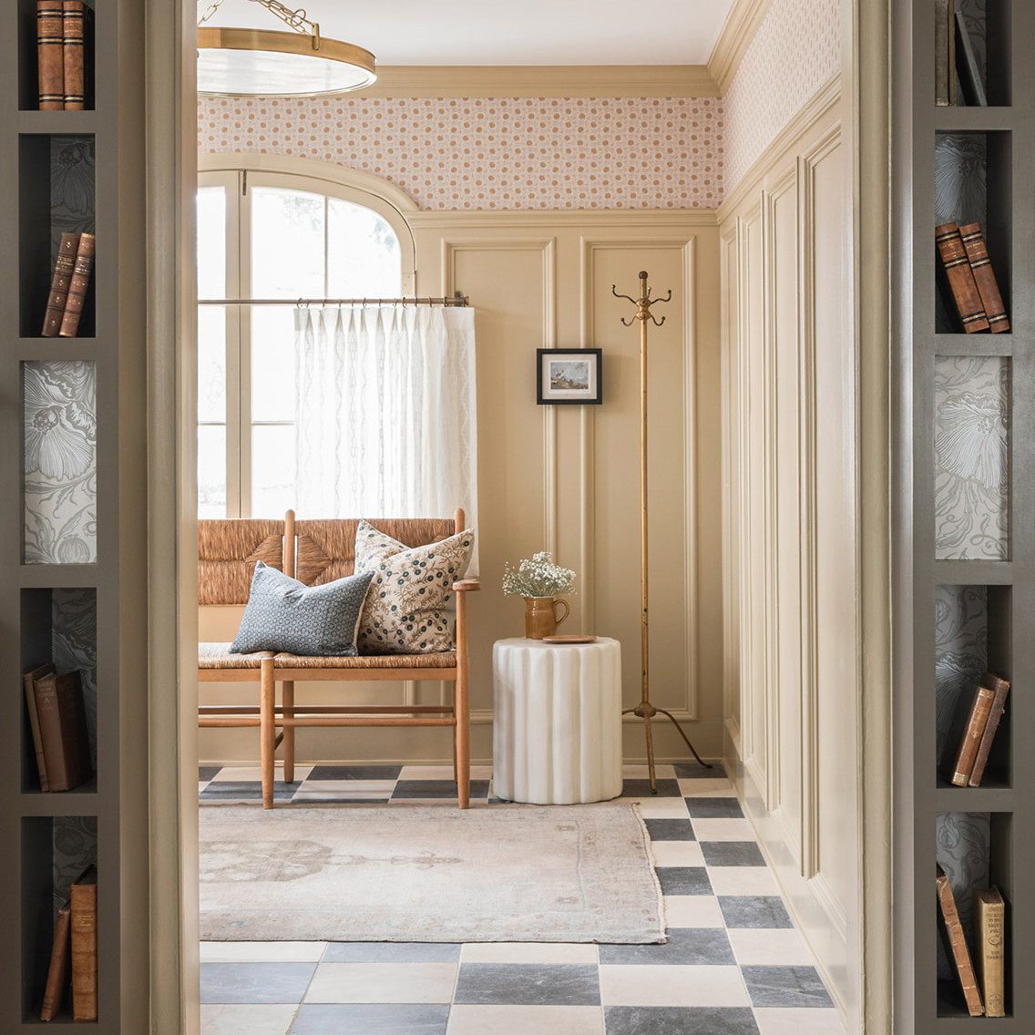 a room with a chair, bookshelf and a clock