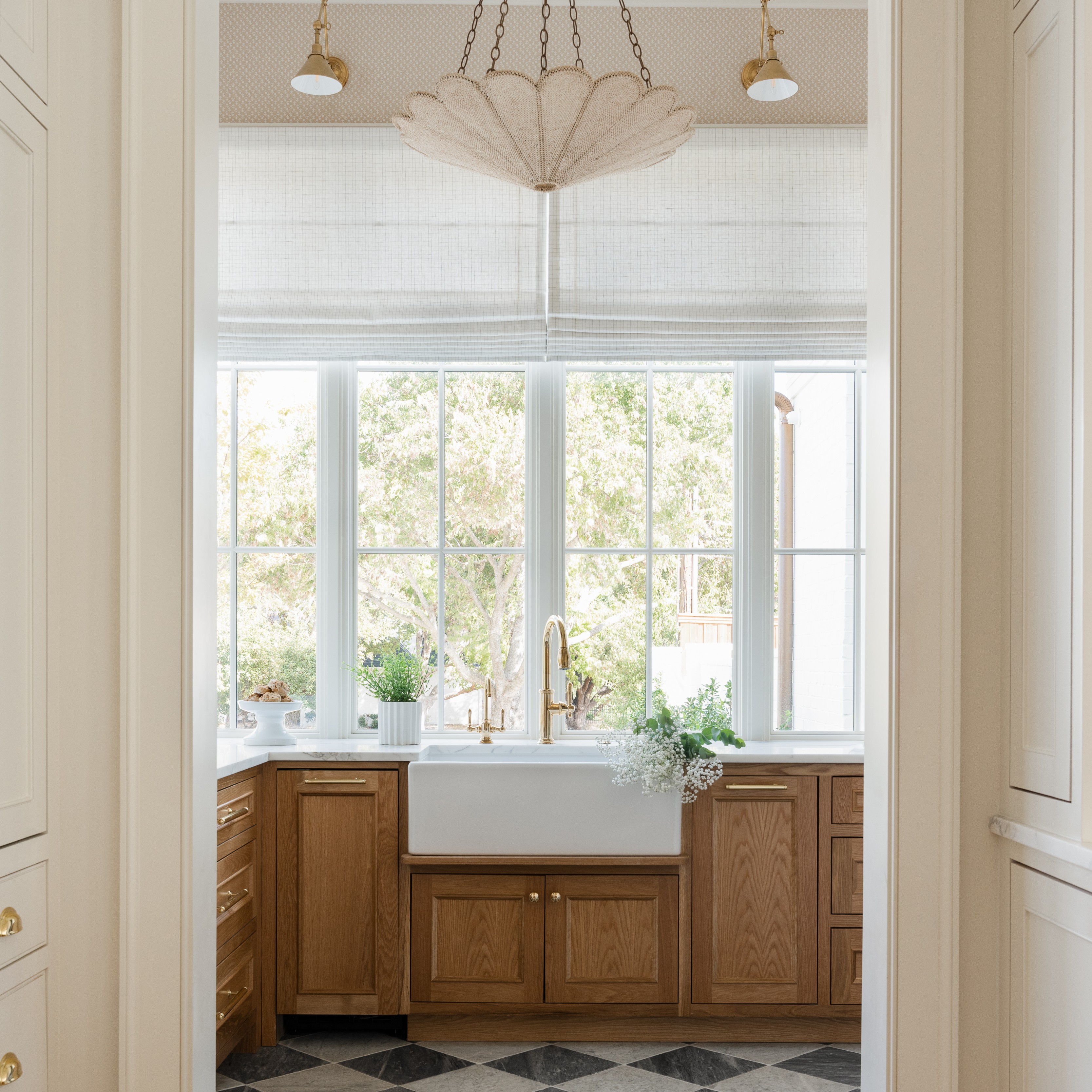 a kitchen with a checkered floor and a chandelier