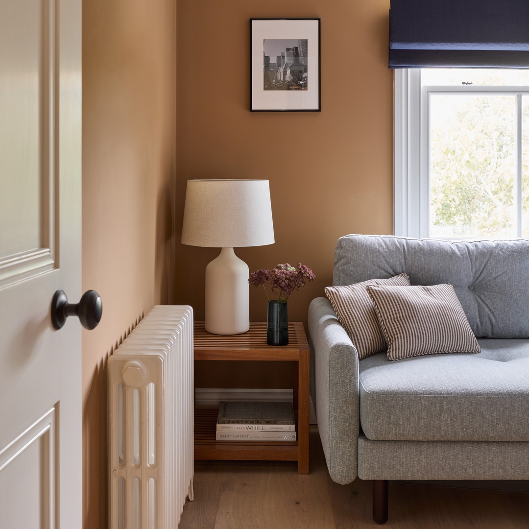 a living room with a couch and a lamp