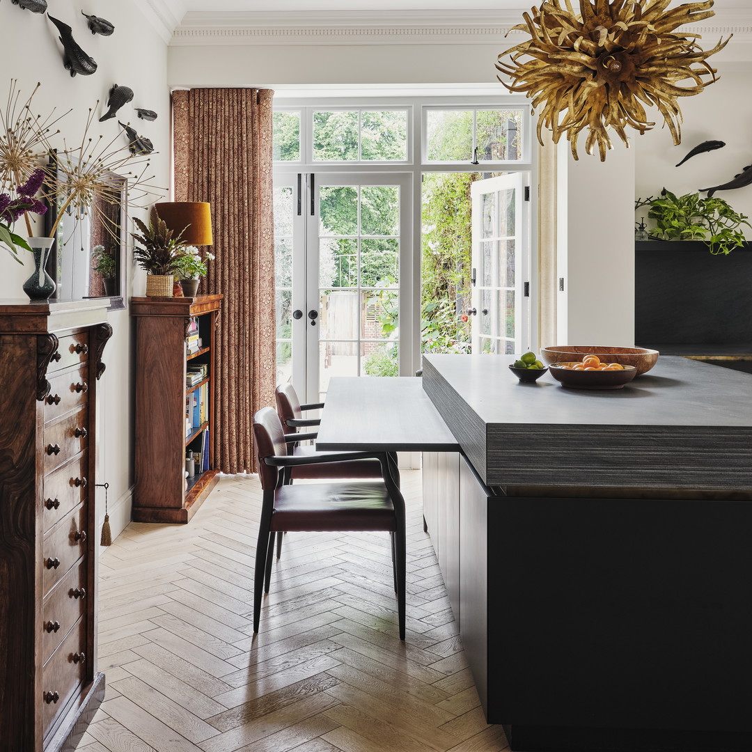 a dining room with a table, chairs and a chandelier