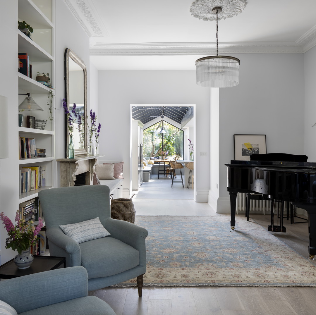 a living room filled with furniture and a piano