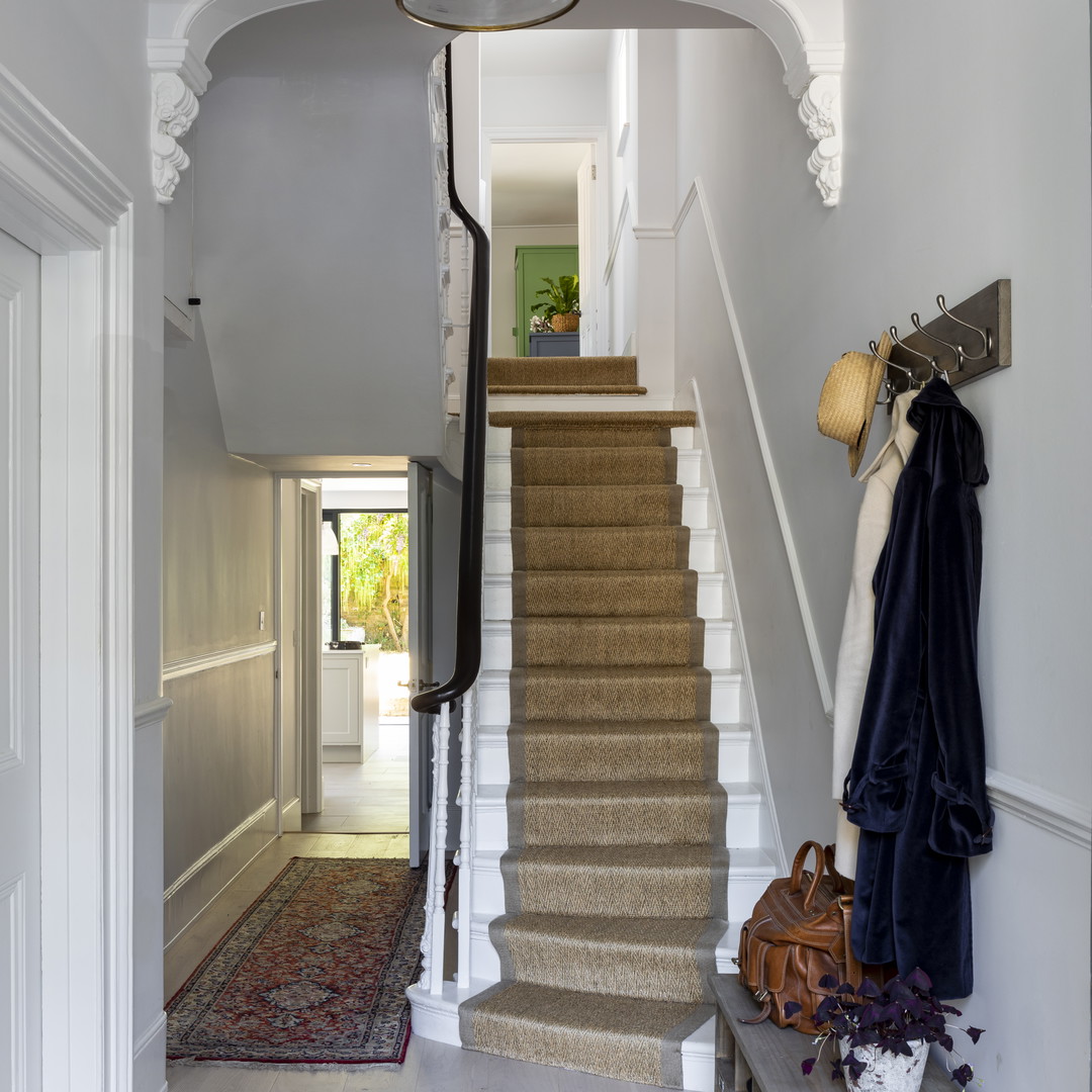 a hallway with a bunch of stairs and a light