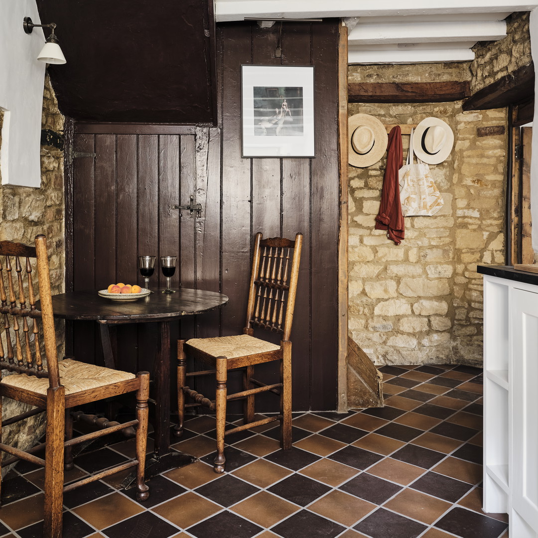 a kitchen with a table and two chairs